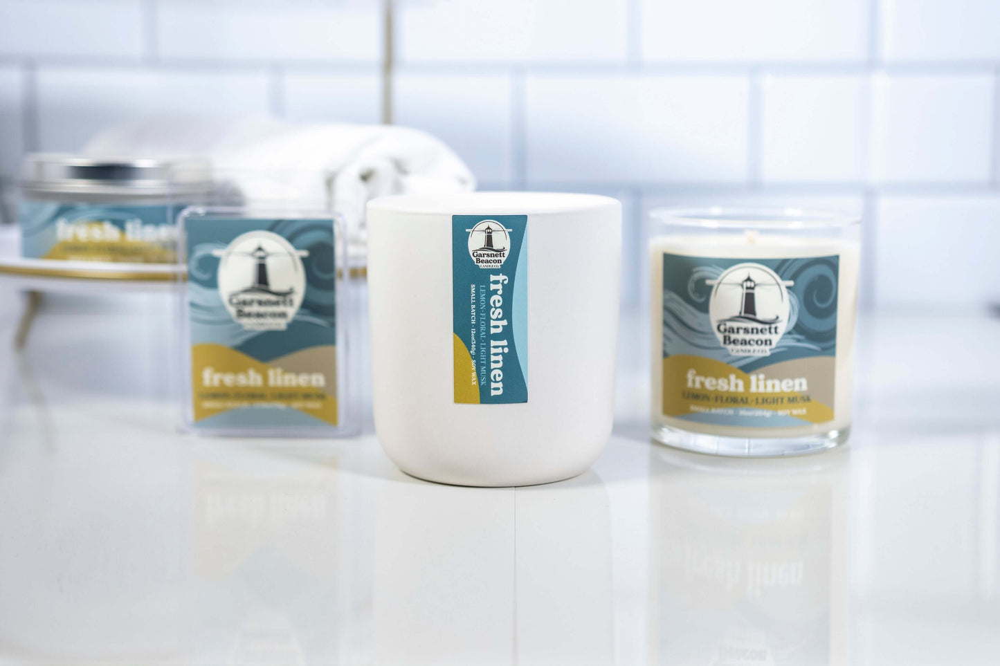 Lemon Linen Floral Ozone Light Musk scented candles called Fresh Linen in glass ceramic tin and wax melts