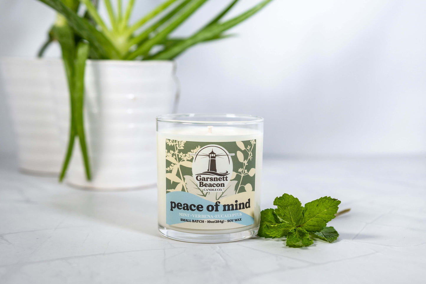 Fresh Mint Verbena Greens Eucalyptus scented candles called Peace of Mind in glass ceramic tin and wax melts
