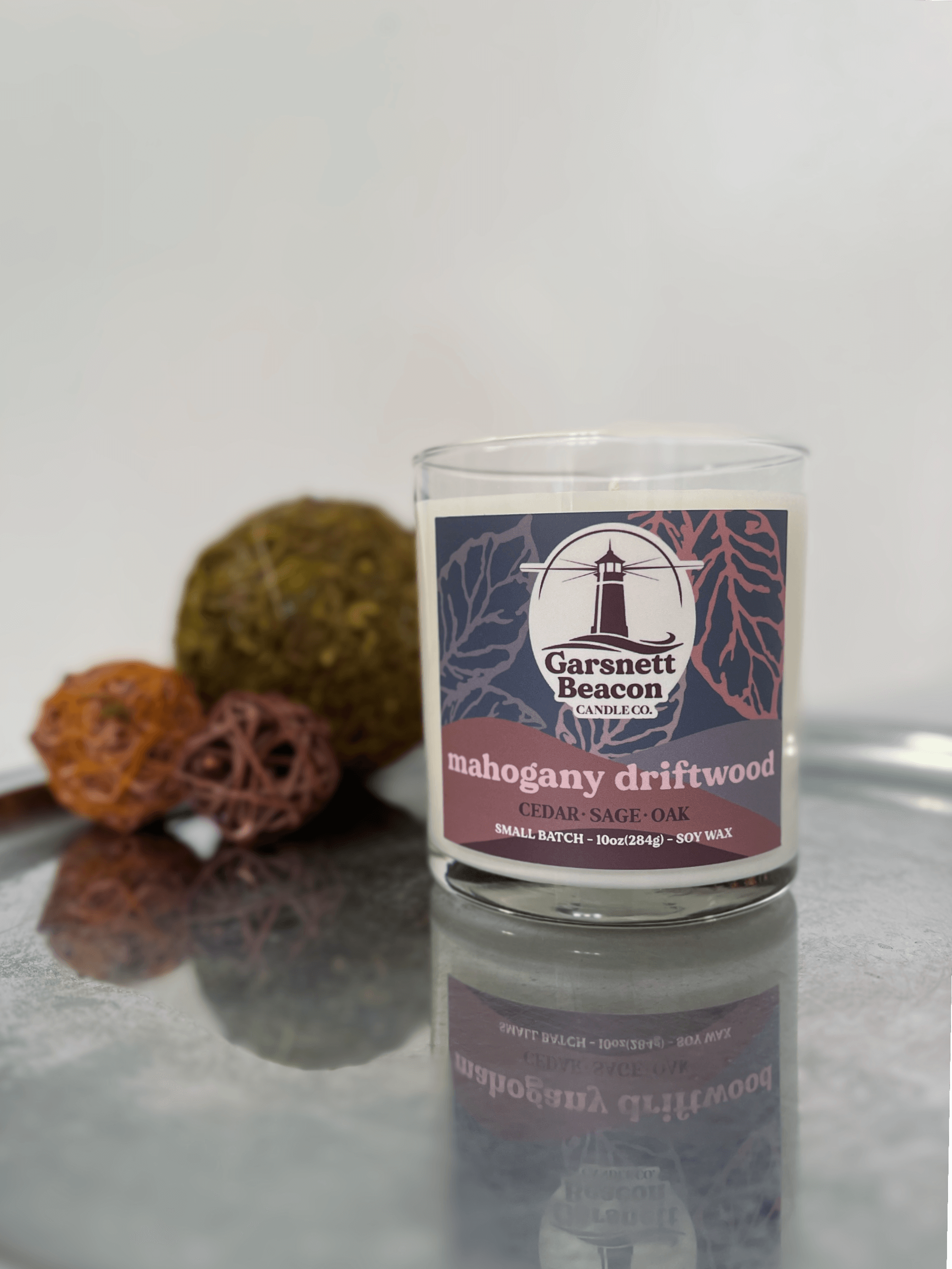 Mahogany Geranium Oak Cedar Eucalyptus Lavender Sage scented candles called Mahogany Driftwood in glass ceramic tin and wax melts