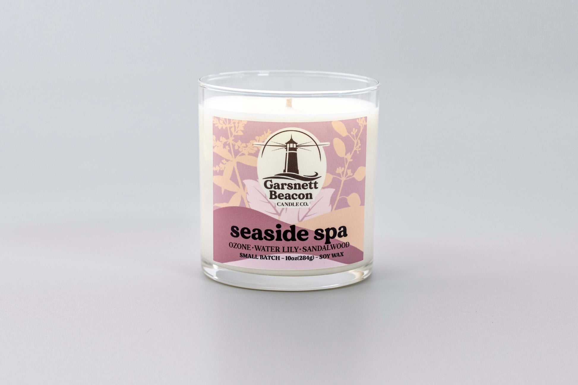Jasmine Water Lily Sandalwood Moss Ozone Apple scented candles called Seaside Spa in glass ceramic tin and wax melts
