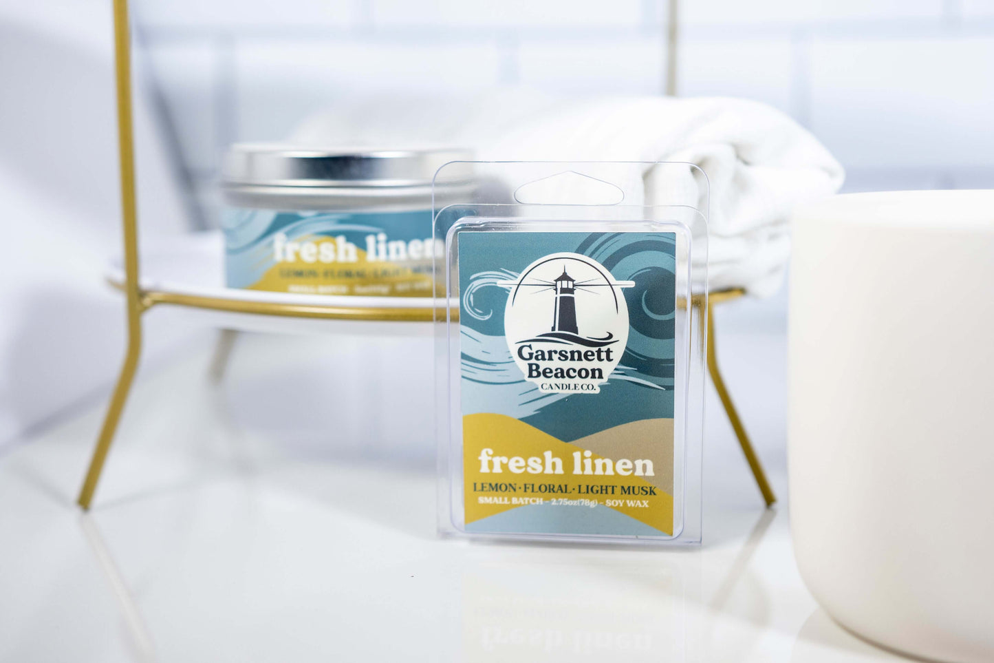 Lemon Linen Floral Ozone Light Musk scented candles called Fresh Linen in glass ceramic tin and wax melts